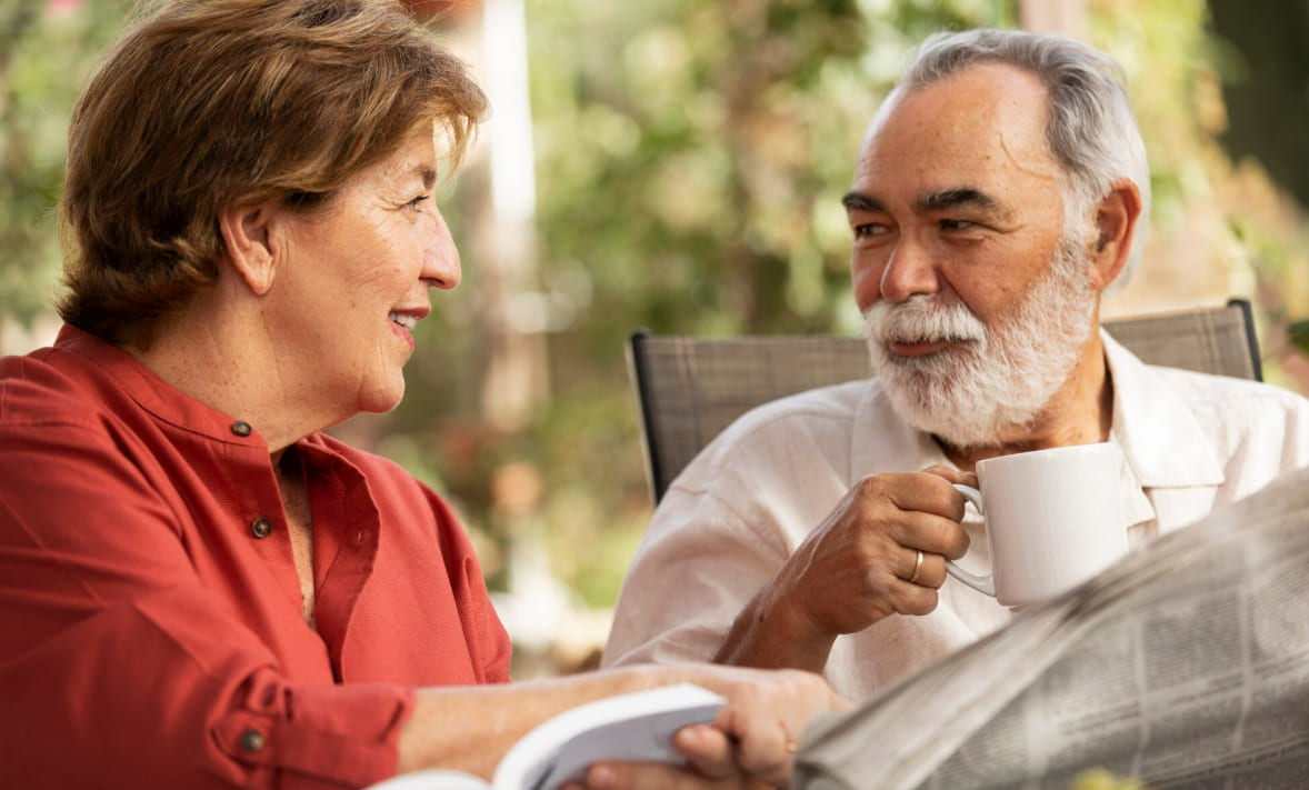 Older adults sharing a conversation over coffee